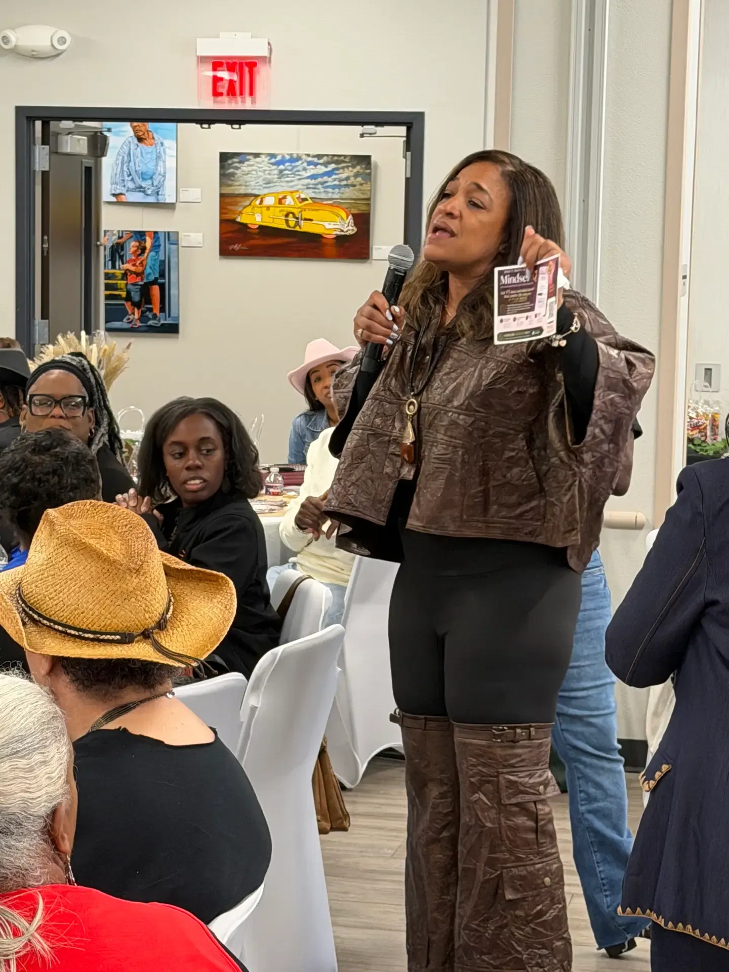 Leah speaking to an audience with a microphone